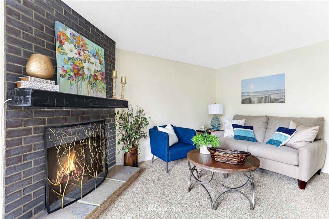 17518 149th Avenue Southeast, Unit 8 Renton, WA 98058 - Photo 4 of 25 a living room with furniture and a fireplace