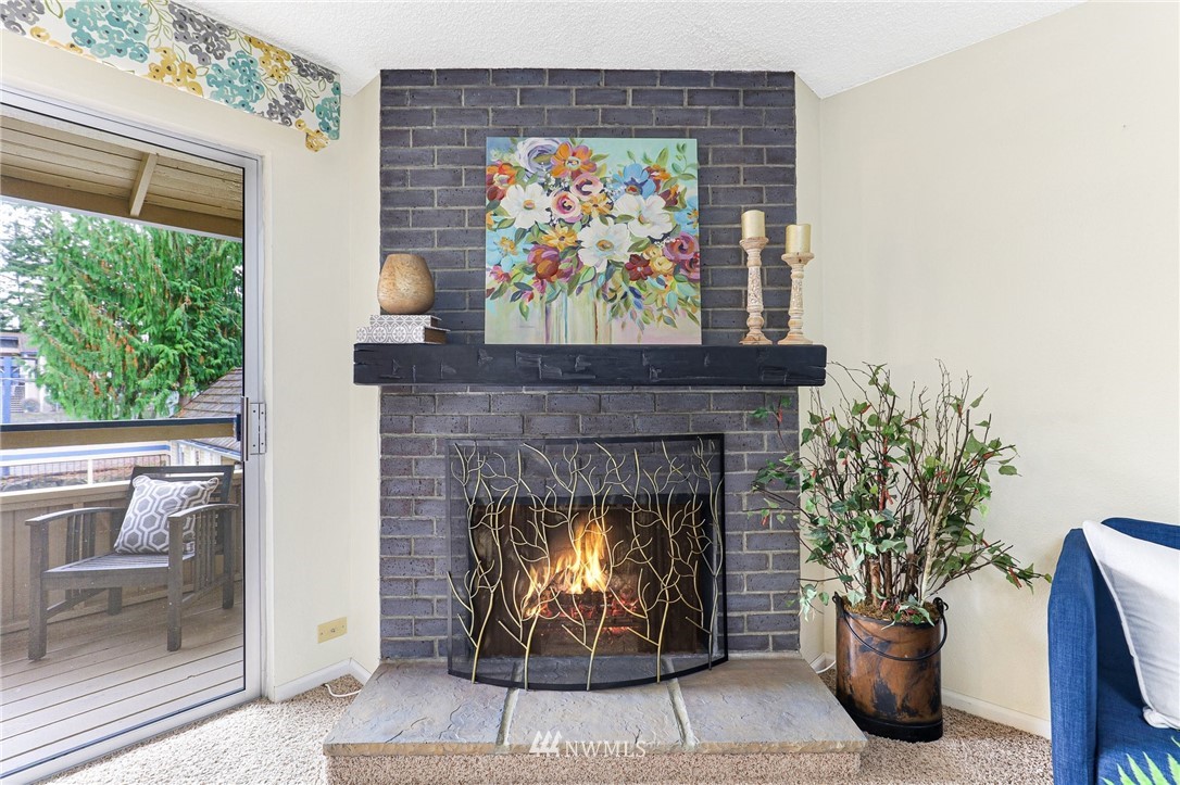 17518 149th Avenue Southeast, Unit 8 Renton, WA 98058 - Photo 9 of 25 a living room with a fireplace and a fireplace