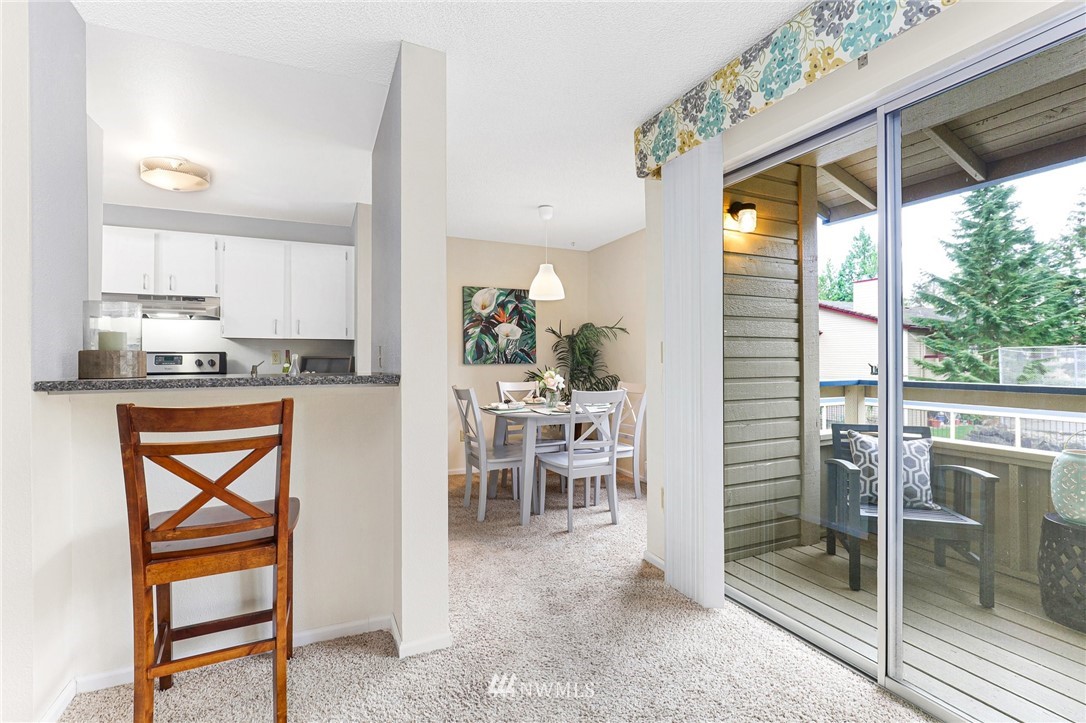 17518 149th Avenue Southeast, Unit 8 Renton, WA 98058 - Photo 10 of 25 a kitchen with stainless steel appliances granite countertop a refrigerator a oven and white cabinets