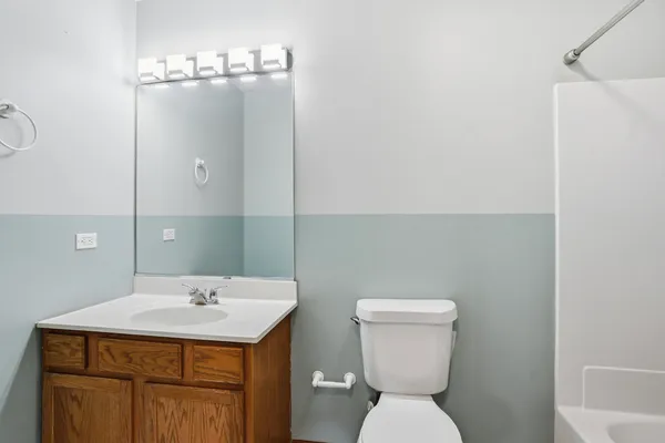 a bathroom with a sink a toilet and mirror
