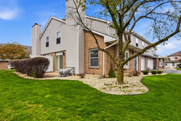 a view of a house with a yard patio and fire pit