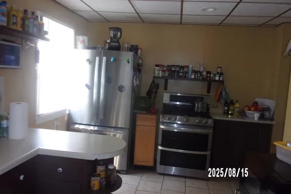 a kitchen with a refrigerator and a stove