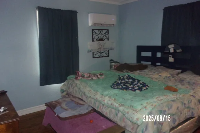 a bedroom with a bed and a dresser