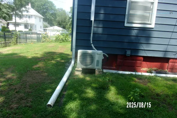 a backyard of a house with table and chairs