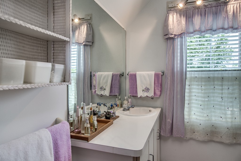 19 Sherman Street, Unit 2 Lexington, MA 02420 - Photo 12 of 15 a bathroom with a sink a mirror and a bathtub