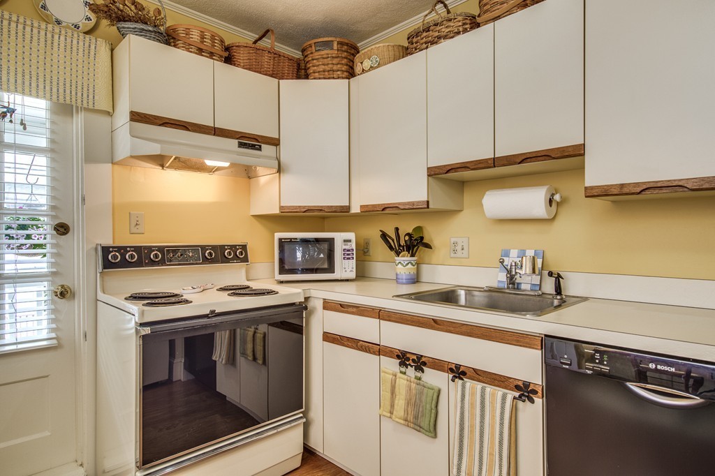 19 Sherman Street, Unit 2 Lexington, MA 02420 - Photo 5 of 15 a kitchen with stainless steel appliances granite countertop a sink stove and cabinets