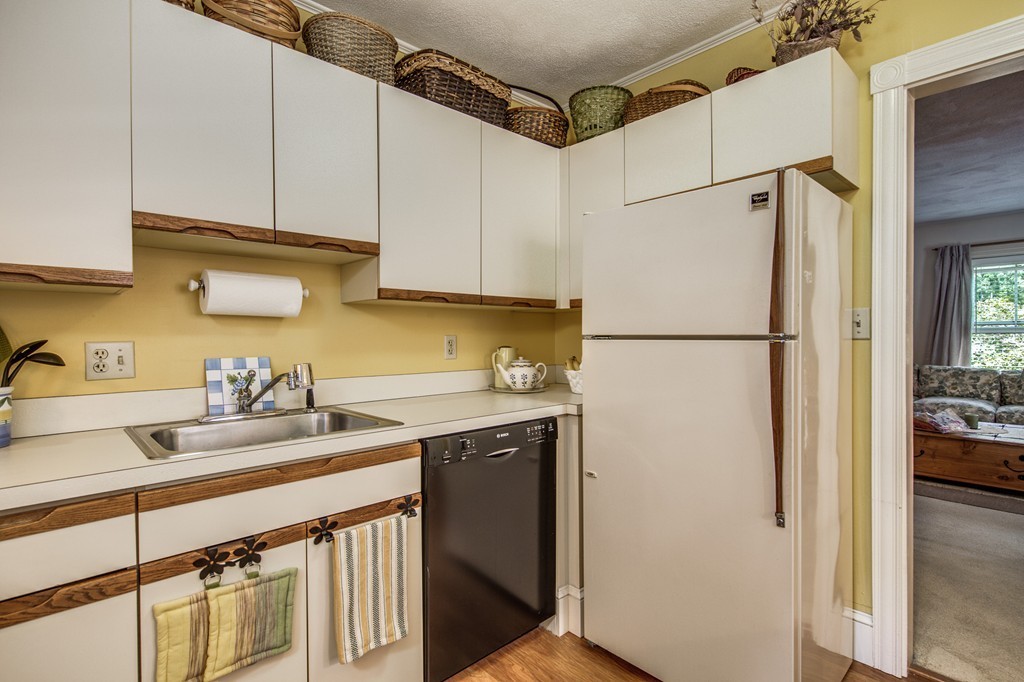 19 Sherman Street, Unit 2 Lexington, MA 02420 - Photo 6 of 15 a kitchen with stainless steel appliances a refrigerator sink and cabinets