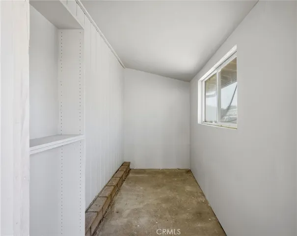 a view of a room with wooden floor and entryway
