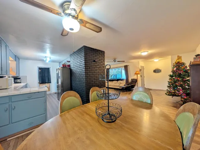 a kitchen with a faucet a chandelier and living room view