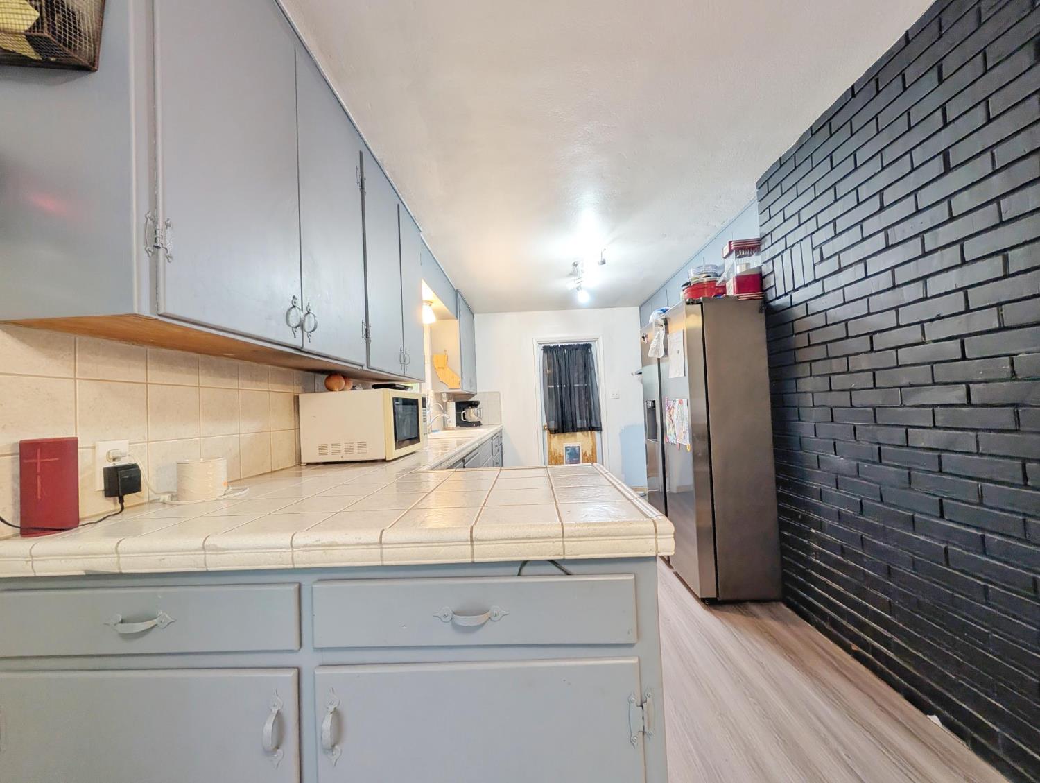 600 Gold Oak Road San Andreas, CA 95249 - Photo 18 of 46 a kitchen with granite countertop white cabinets and stainless steel appliances