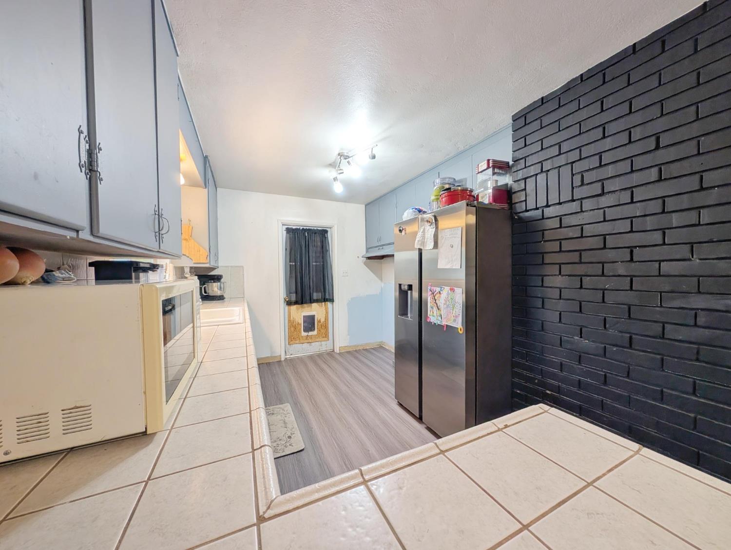 600 Gold Oak Road San Andreas, CA 95249 - Photo 22 of 46 a view of a refrigerator in kitchen and an empty room