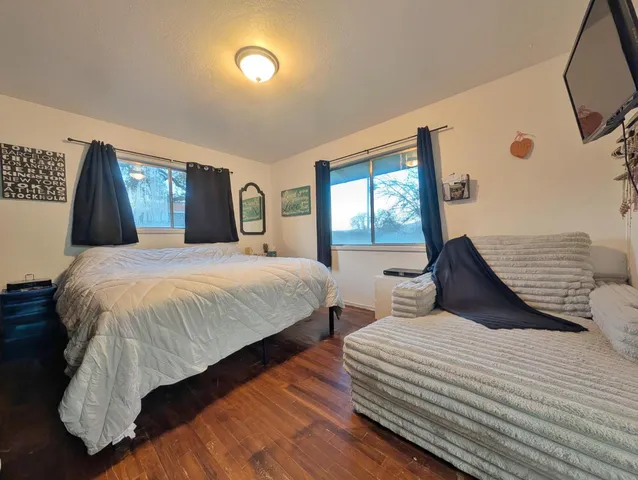 a bedroom with double bed and a window