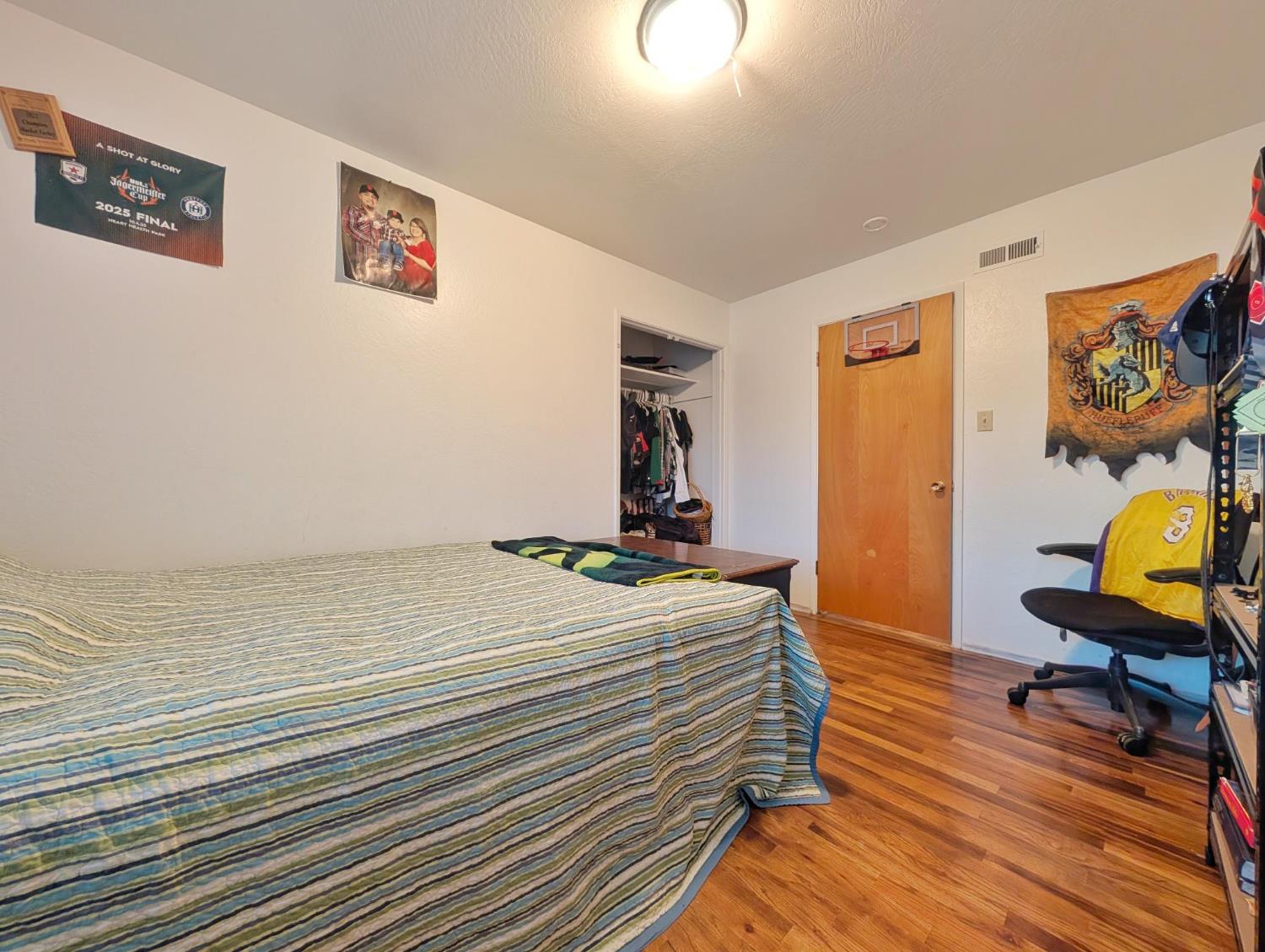 600 Gold Oak Road San Andreas, CA 95249 - Photo 30 of 46 a bedroom with a bed and wooden floor