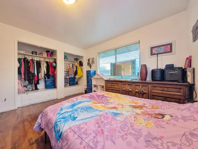 a bed room with a large bed and a large mirror