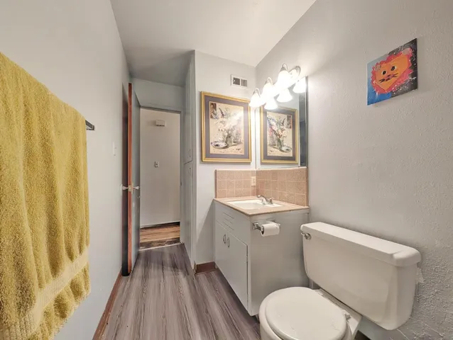 a white toilet sitting next to a bathroom sink