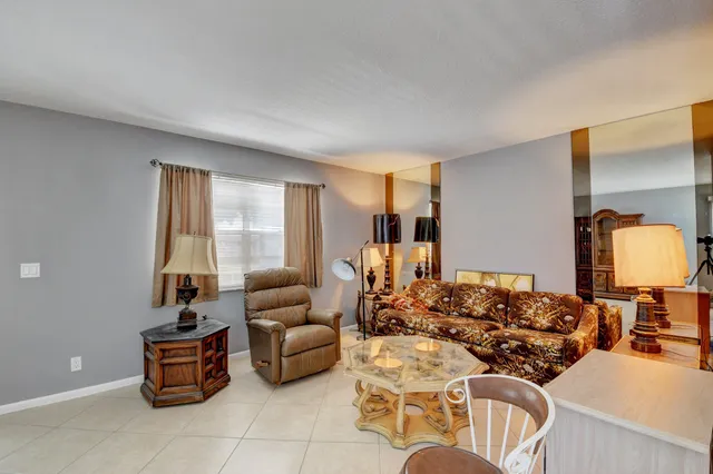 a living room with furniture and a lamp