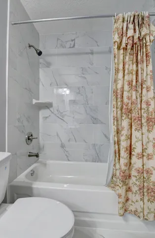 a bathroom with a bathtub and shower