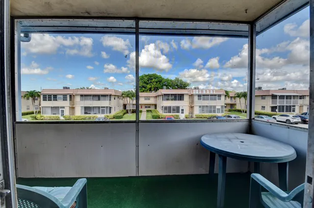 a view of a living room and floor to ceiling window or kitchen