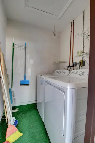 a front view of a house with a yard and potted plants
