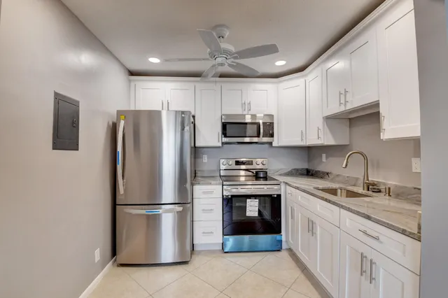 a kitchen with stainless steel appliances granite countertop a refrigerator stove a sink and dishwasher