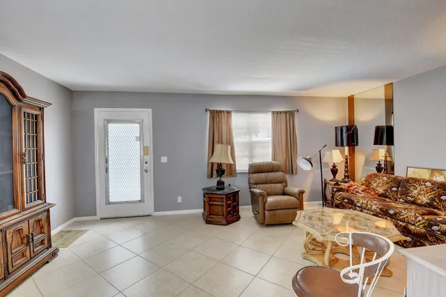 a living room with furniture a window and gym equipment
