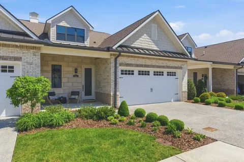 a front view of a house with a yard and outdoor seating