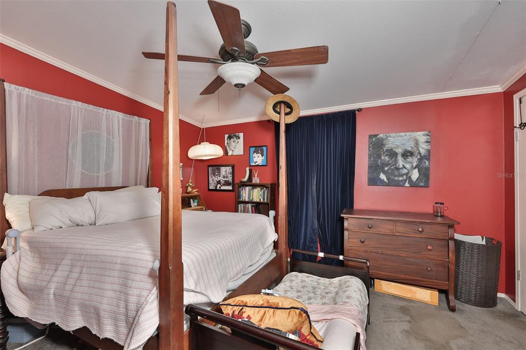 20112 Hobbs Road Wimauma, FL 33598 - Photo 29 of 94 a bedroom with a bed and lamp with the dresser