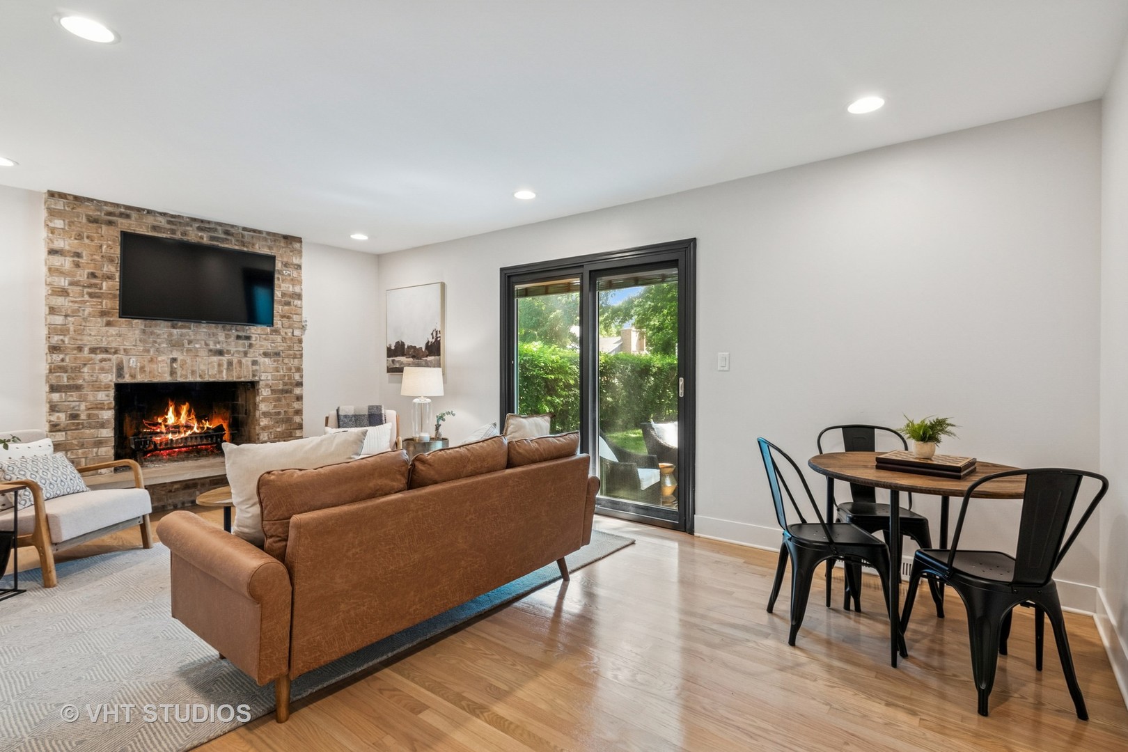 1575 Burning Trail Wheaton, IL 60189 - Photo 15 of 34 a living room with furniture a flat screen tv and a fireplace