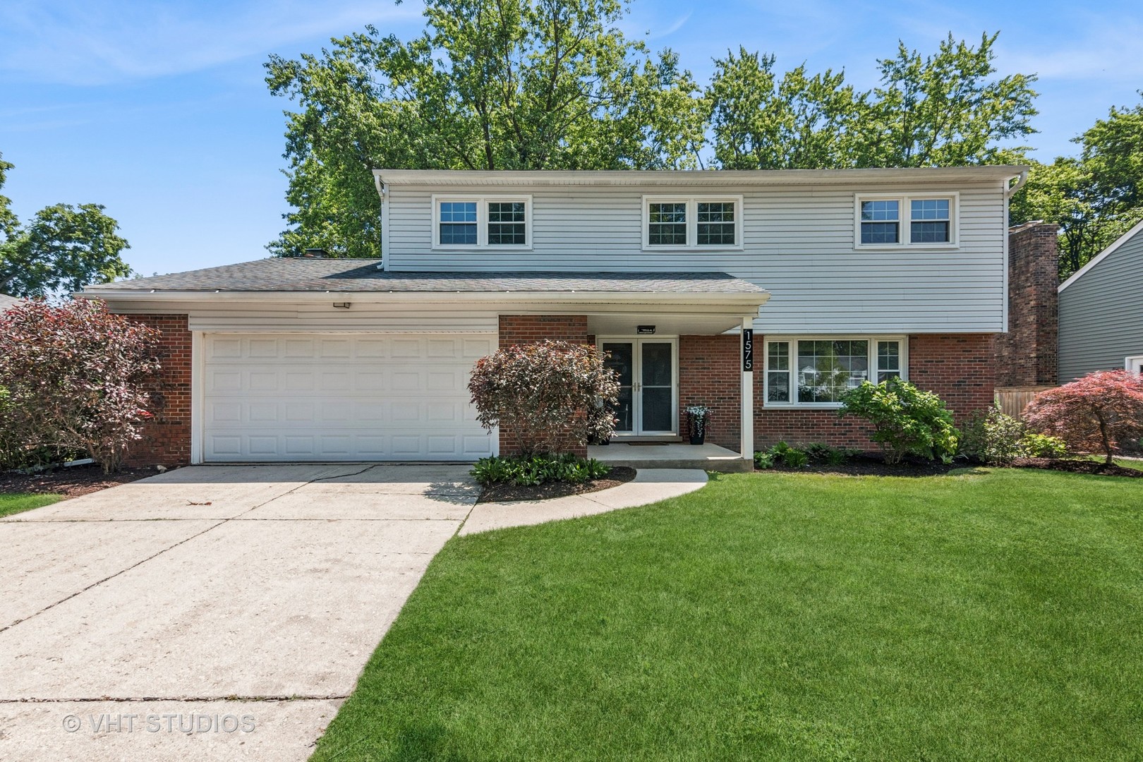 1575 Burning Trail Wheaton, IL 60189 - Photo 2 of 34 a front view of a house with a garden and yard