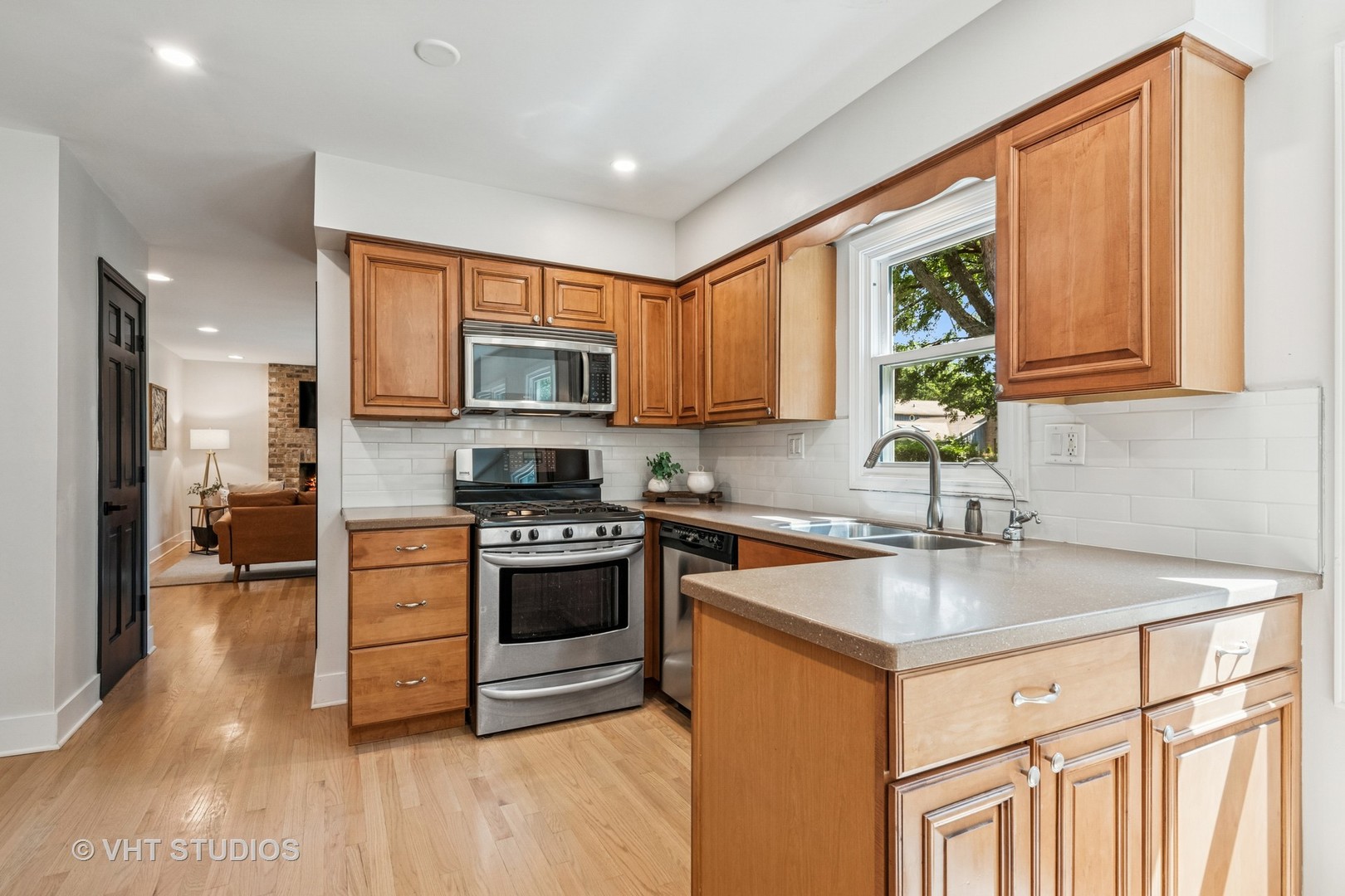 1575 Burning Trail Wheaton, IL 60189 - Photo 10 of 34 a kitchen with stainless steel appliances granite countertop a stove a sink dishwasher and a microwave oven with cabinets