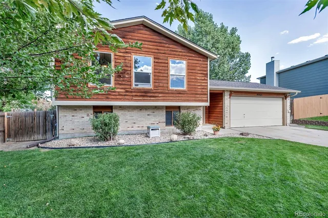 a front view of a house with a yard and a fence