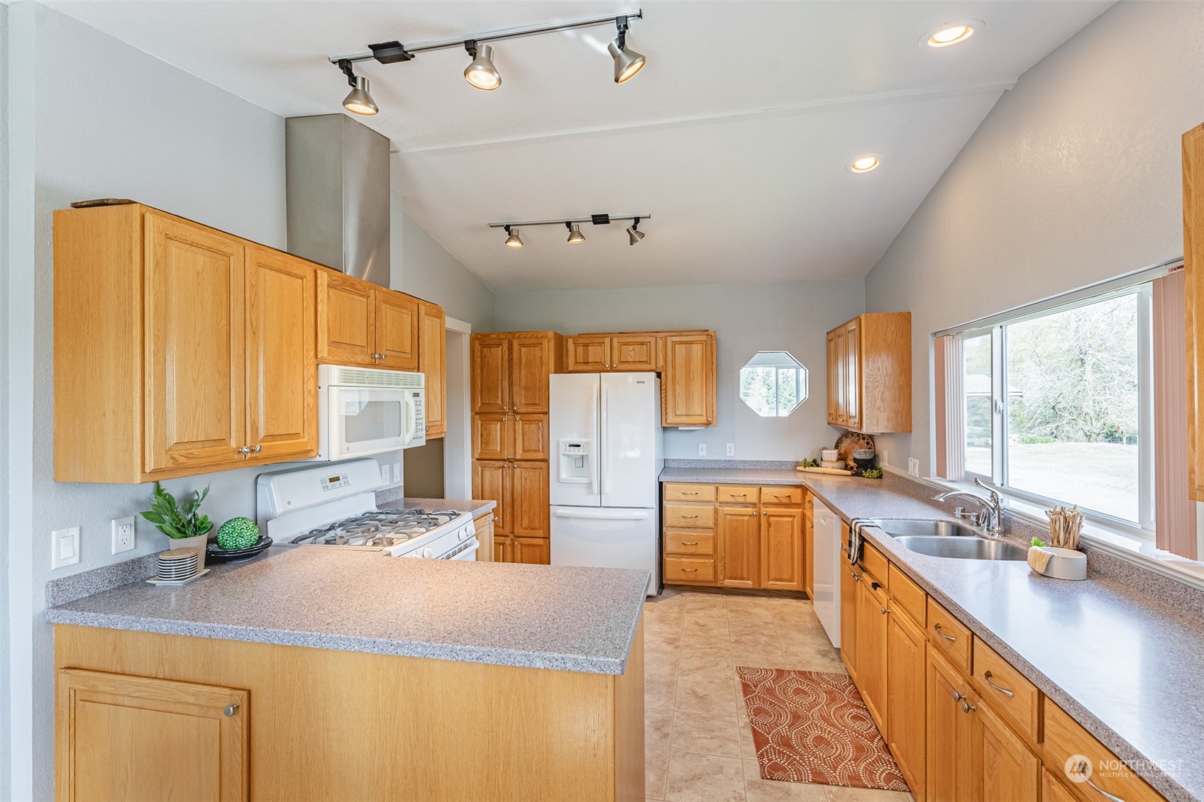 940 West Axton Road Ferndale, WA 98248 - Photo 6 of 40 a kitchen with stainless steel appliances granite countertop sink stove and refrigerator