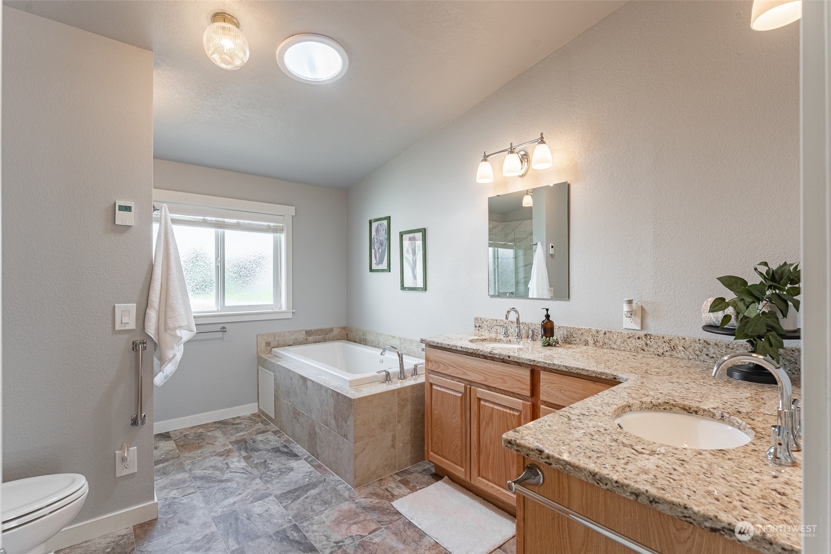 940 West Axton Road Ferndale, WA 98248 - Photo 10 of 40 a spacious bathroom with a granite countertop sink and a mirror