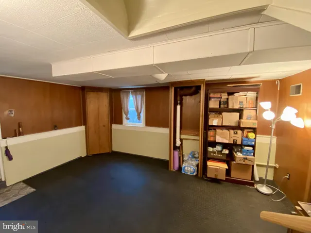 a spacious bedroom with a bed and a window