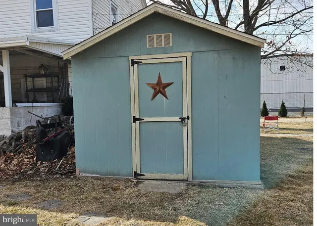 a couple of table and chairs in front of door