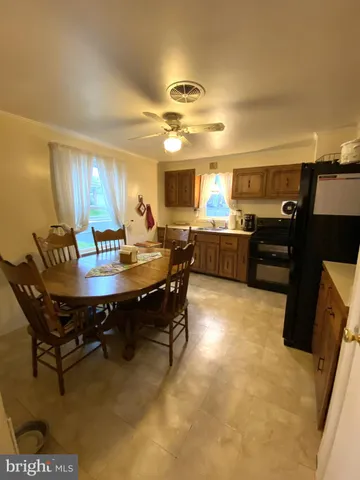 a dining room with a wooden table and chairs