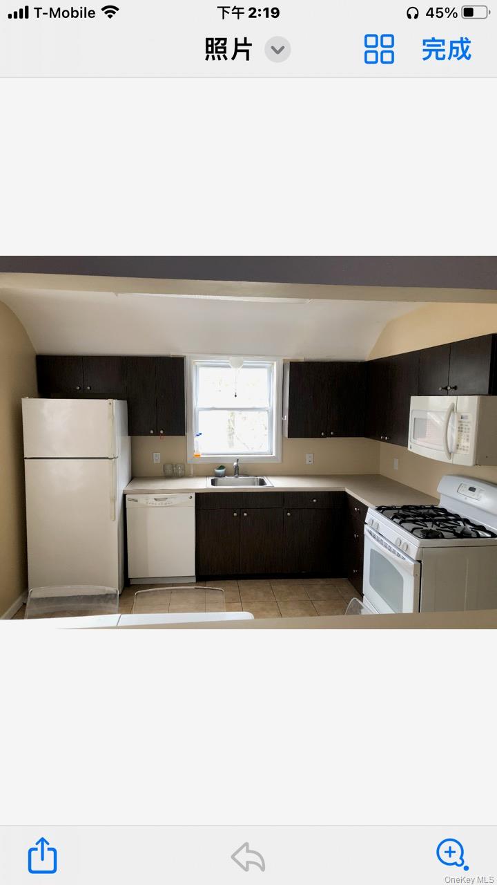 685 Walt Whitman Road, Unit 2 Melville, NY 11747 - Photo 1 of 5 a kitchen with a stove two white cabinets