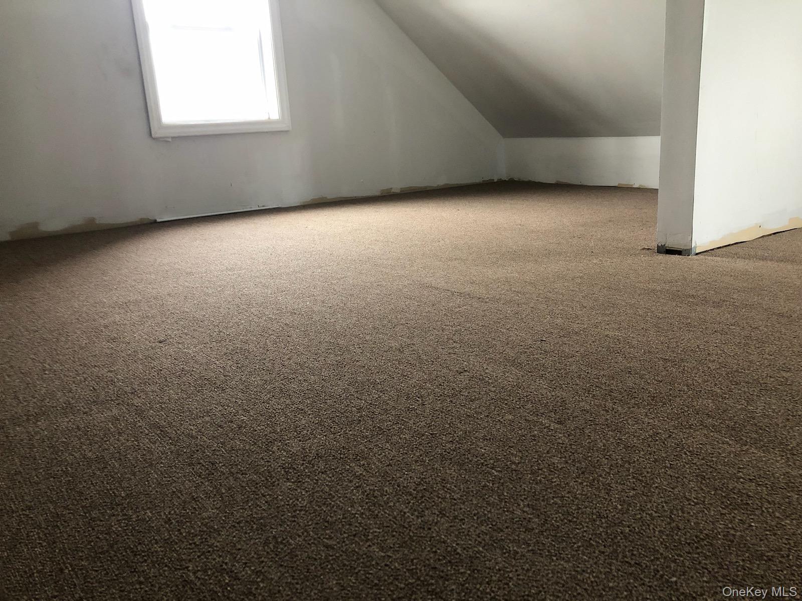 685 Walt Whitman Road, Unit 2 Melville, NY 11747 - Photo 4 of 5 an empty room with a window