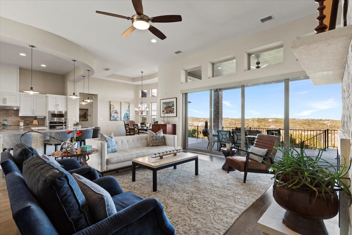 17825 Windecker Cove Dripping Springs, TX 78620 - Photo 1 of 39 a living room with furniture and a large window