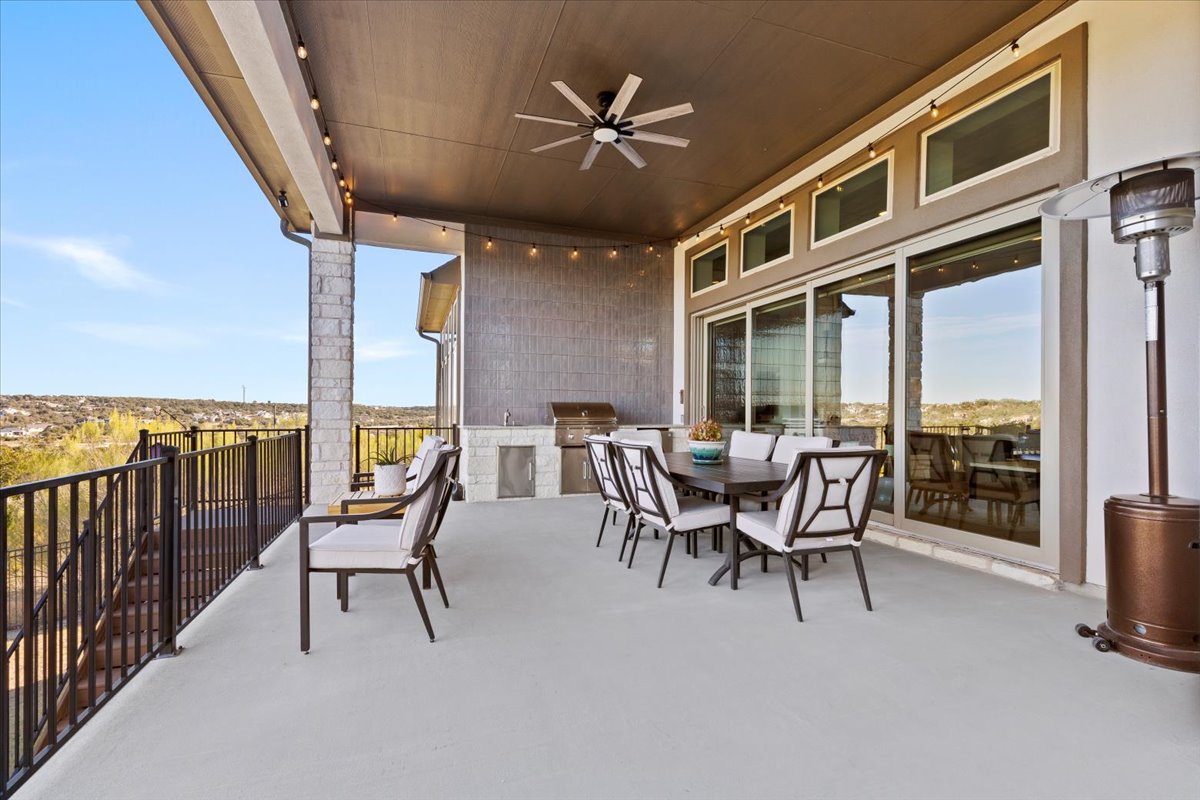 17825 Windecker Cove Dripping Springs, TX 78620 - Photo 14 of 39 a dining room with furniture and a floor to ceiling window