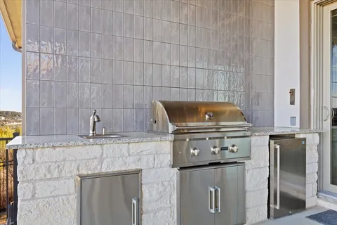 a view of a house with backyard and sitting area