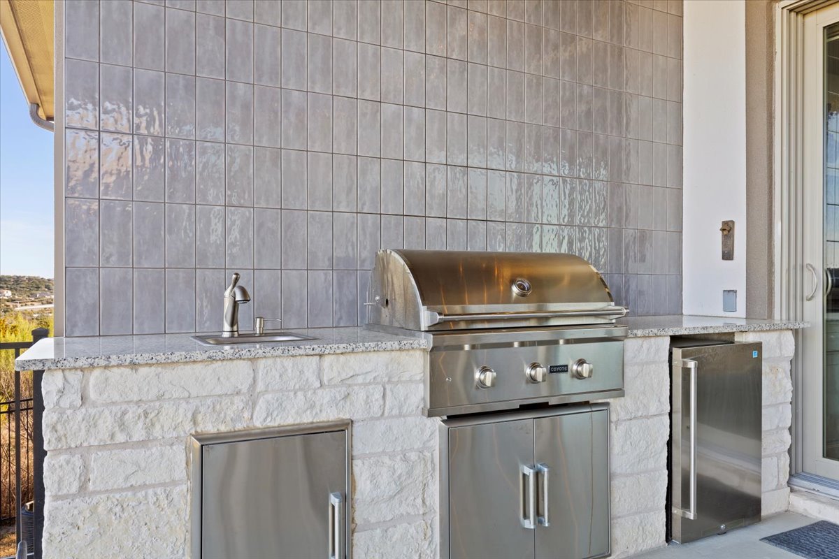 17825 Windecker Cove Dripping Springs, TX 78620 - Photo 15 of 39 a stove top oven sitting inside of a kitchen