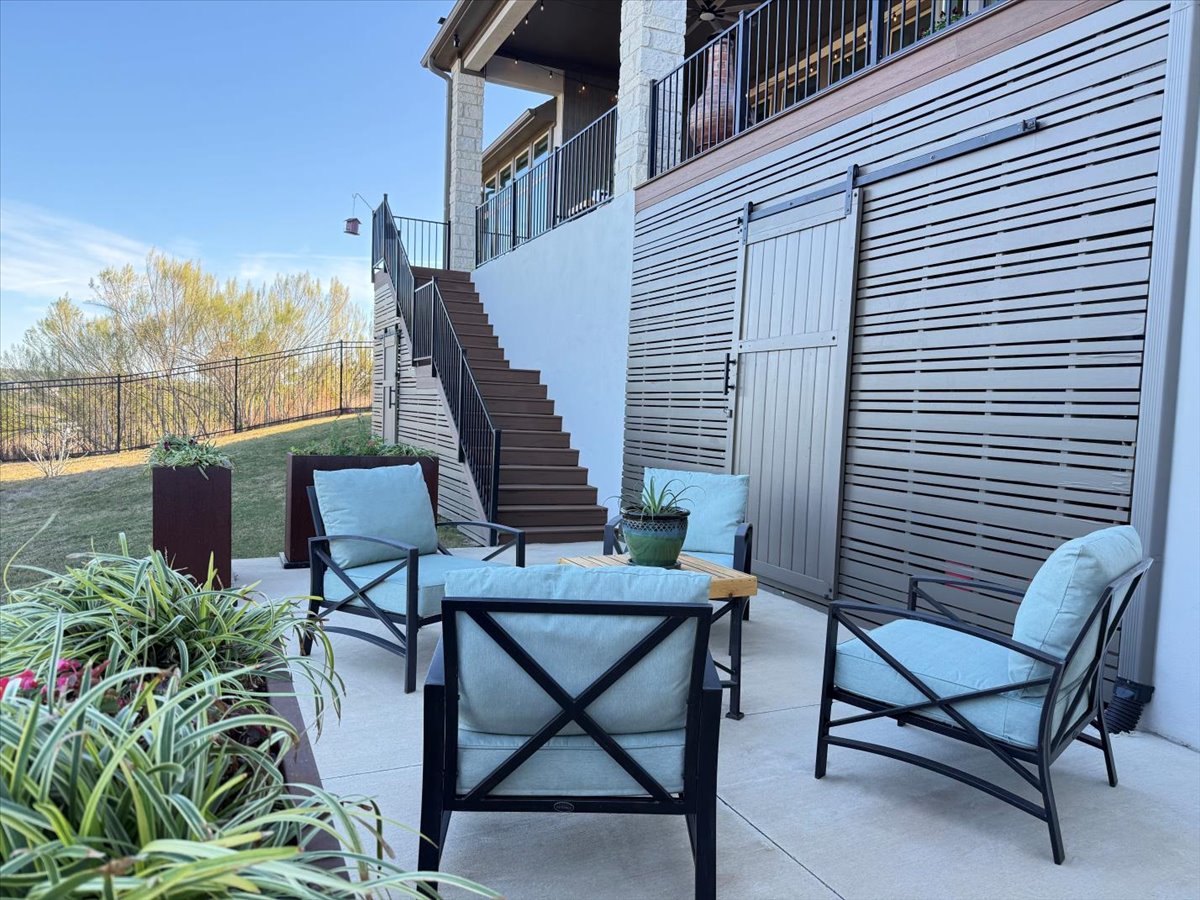 17825 Windecker Cove Dripping Springs, TX 78620 - Photo 17 of 39 a view of a patio with a table and chairs