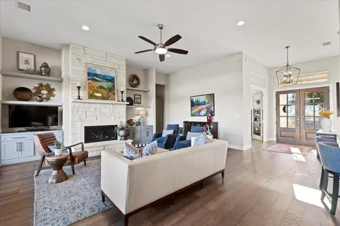 a living room with furniture and wooden floor