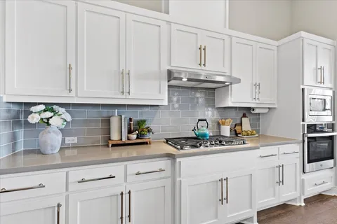 a living room with furniture kitchen view and a table