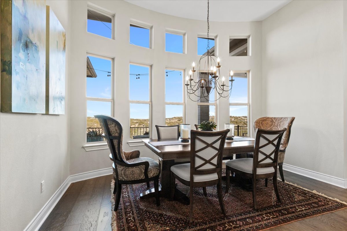 17825 Windecker Cove Dripping Springs, TX 78620 - Photo 25 of 39 a view of a dining room with furniture and chandelier