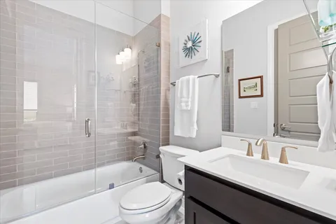 a living room with furniture a flat screen tv and a large window