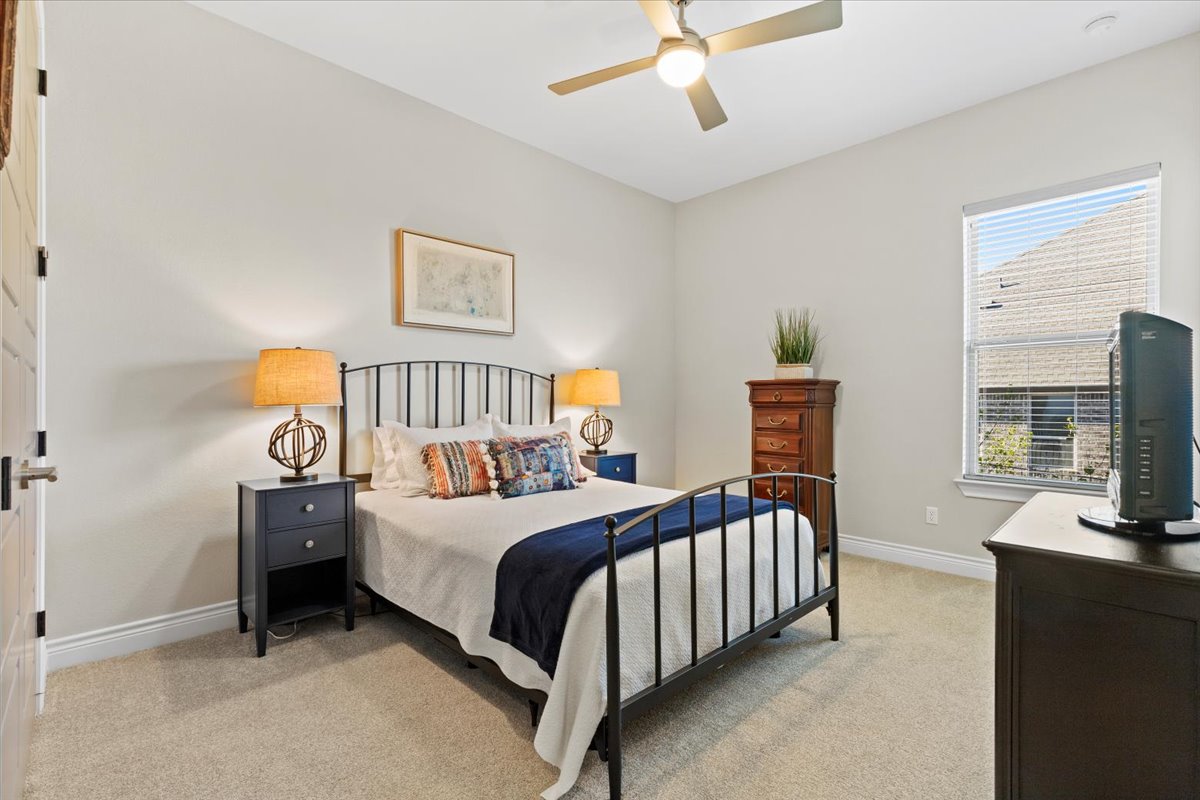 17825 Windecker Cove Dripping Springs, TX 78620 - Photo 29 of 39 a bedroom with a bed and a tv