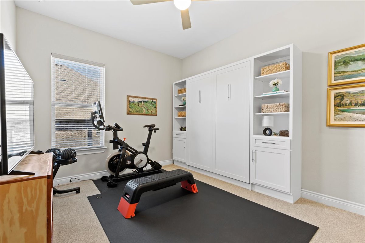 17825 Windecker Cove Dripping Springs, TX 78620 - Photo 31 of 39 a living room with furniture gym equipment and a window