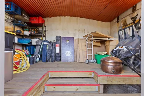 a living room with furniture gym equipment and a window